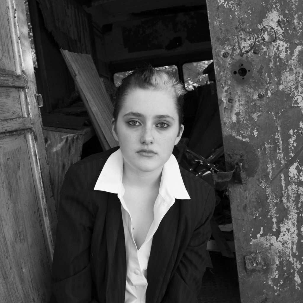 Beautiful androgynously dressed young woman in black and white.